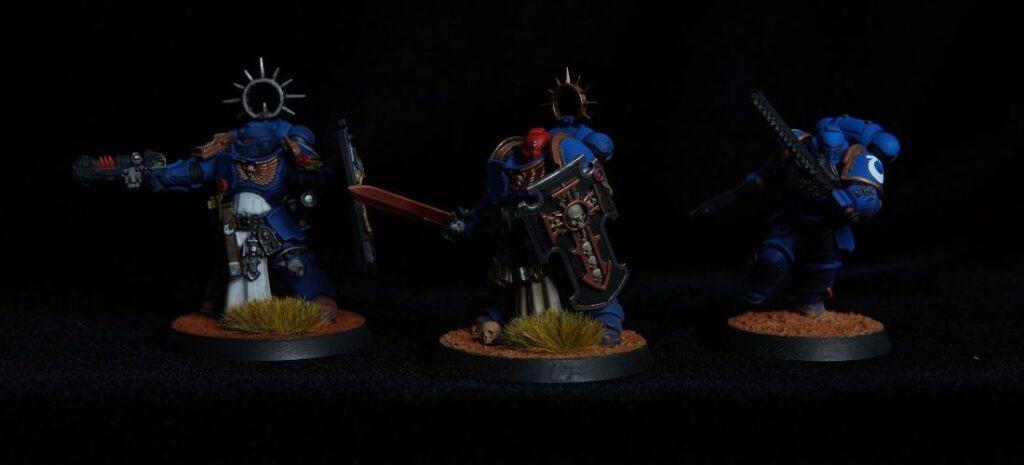 Painted Warhammer 40k Indomitus miniatures on a dark background.